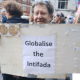 Tony Greenstein holding the 'Globalise the Intifada' slogan poster at the Nakba Day march in London on 16 May 2026
