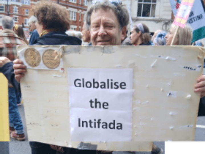 Tony Greenstein holding the 'Globalise the Intifada' slogan poster at the Nakba Day march in London on 16 May 2026