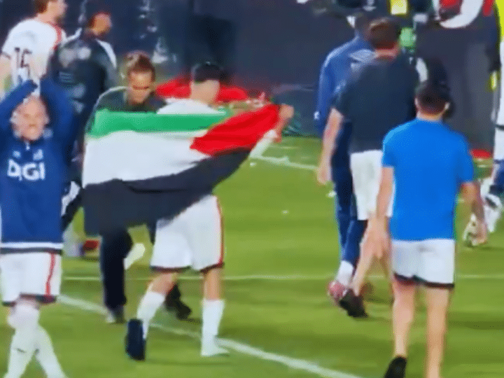Akhomach celebrates with the Palestinian flag after his team Rayo Vallecano’s win over Strasbourg