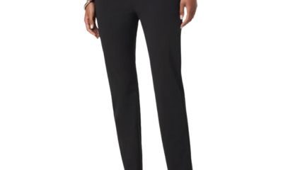 A woman (lower half of body shown) wearing black pants and black thong sandals