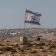 A tattered Israel flag flies near a West Bank settlement