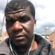 Selfie image of Yves Sakila with ear phone wires hanging from his ears