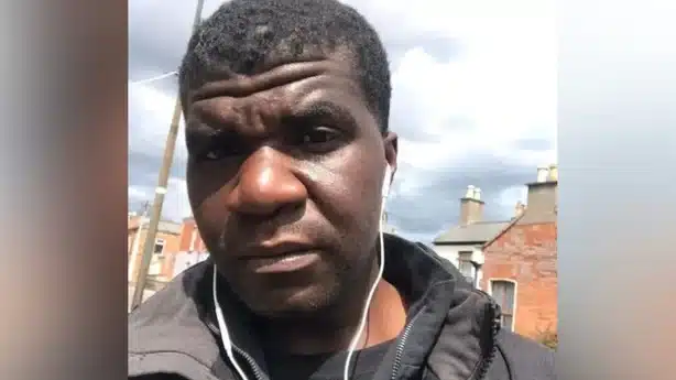 Selfie image of Yves Sakila with ear phone wires hanging from his ears