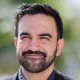 A sunny head shot of Zohran Mamdani