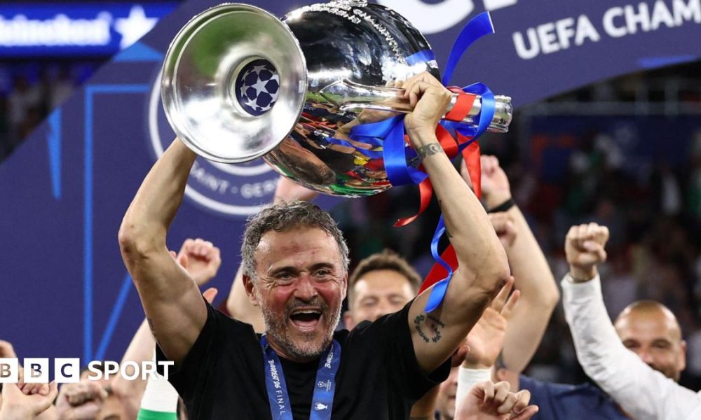 Paris St-Germain manager Luis Enrique smiling with the Champions League trophy