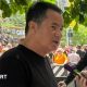 Hull City owner Acun Ilicali being interviewed outside Wembley Stadium, wearing a black t-shirt. Crowds on Olympic Way can be seen behind him.