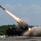 Japan's defence minister denies militarism and criticises China's 'huge arsenal'