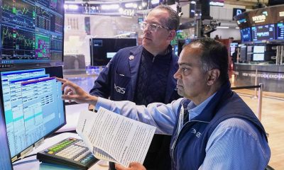 Wall St ends slightly higher as investors watch Iran