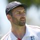 Mark Wood, wearing a blue England cap, looks to the side