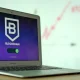 Laptop displaying a blockchain login screen with connecting status.