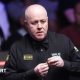 John Higgins lines up a shot