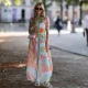 Anna Wolfers wearing colorful wrap dress via Goldig Shop, pink Moschino leather bag and brown heeled clogs on May 31, 2021 in Hamburg, Germany