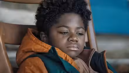a tear trickles down a young child's cheek in 'Elevation'