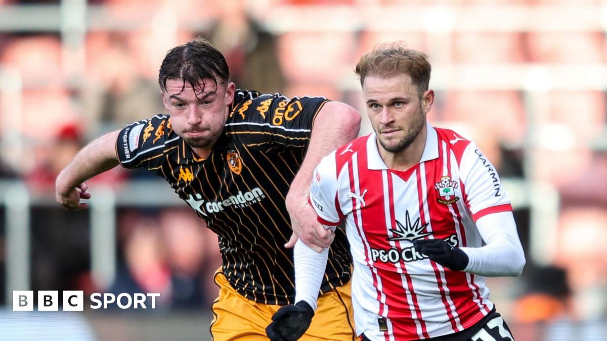 Hull defender Charlie Hughes has his left hand on the right shoulder of Southampton player Leo Scienza, who is wearing gloves