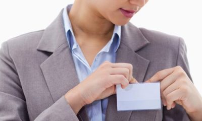 stylish professional woman affixes an ID badge to her blazer