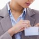 stylish professional woman affixes an ID badge to her blazer