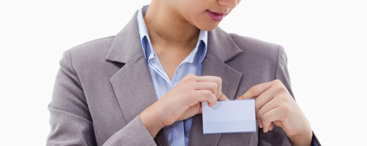 stylish professional woman affixes an ID badge to her blazer