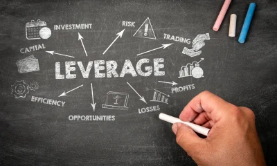 LEVERAGE Concept. Illustration with icons, arrows and keywords on a black chalkboard background