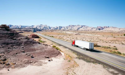 Truck on a desert road leading into the distance
