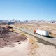 Truck on a desert road leading into the distance