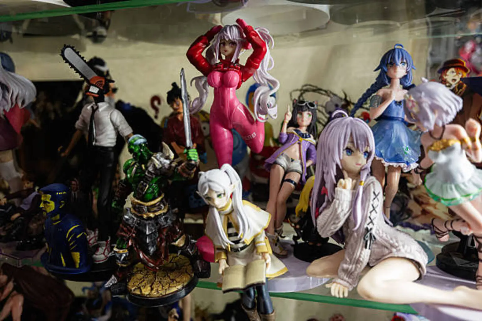 Collection of Various Anime and Manga Figures Displayed in a Glass Shelf