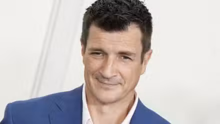 Nathan Fillion smiling at a public appearance