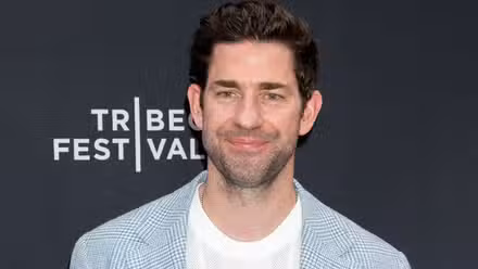 John Krasinski smiling on red carpet 