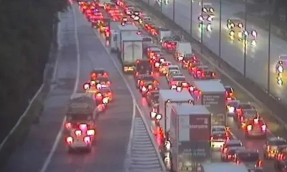 Two rushed to hospital after car flips on its roof and fuel spills across major motorway