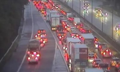 Two rushed to hospital after car flips on its roof and fuel spills across major motorway