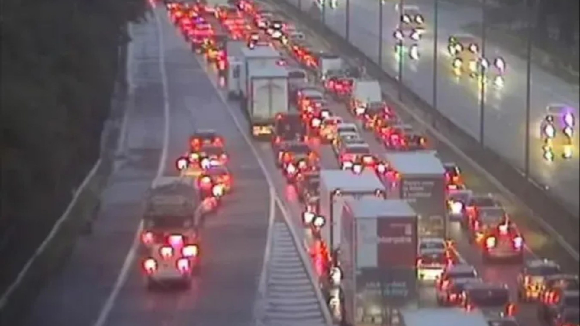 Two rushed to hospital after car flips on its roof and fuel spills across major motorway