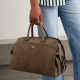 woman carries brownish suede tote