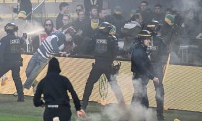French League match cancelled after fans storm pitch