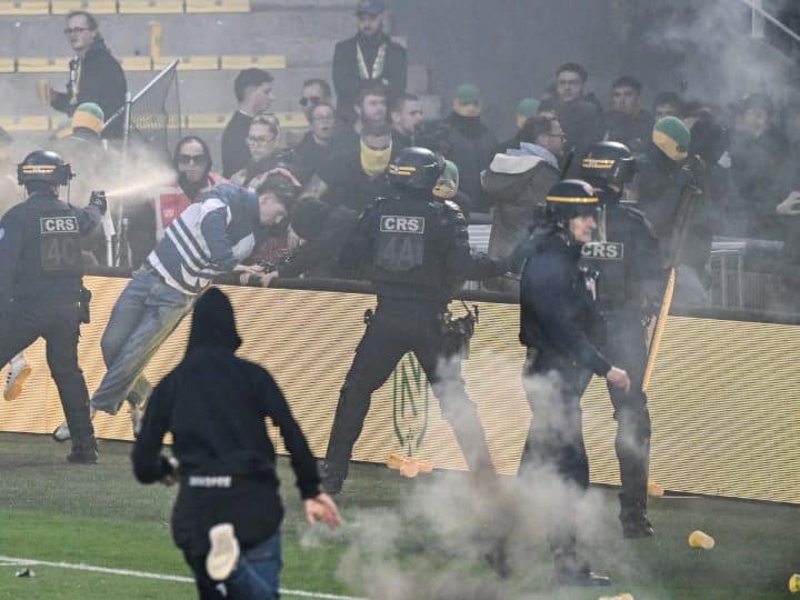 French League match cancelled after fans storm pitch