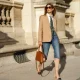 PARIS, FRANCE - AUGUST 03: Natalia Verza wears sunglasses from Celine, a Paul & Joe beige blazer jacket, a white shirt, a colored floral print tie from Paul & Joe, blue denim ripped short jeans, a Prada brown leather bag, Chanel slingback shoes, on August 03, 2020 in Paris, France. (Photo by Edward Berthelot/Getty Images)