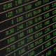 Close-up of a digital stock market display showing various stock prices and trading data.