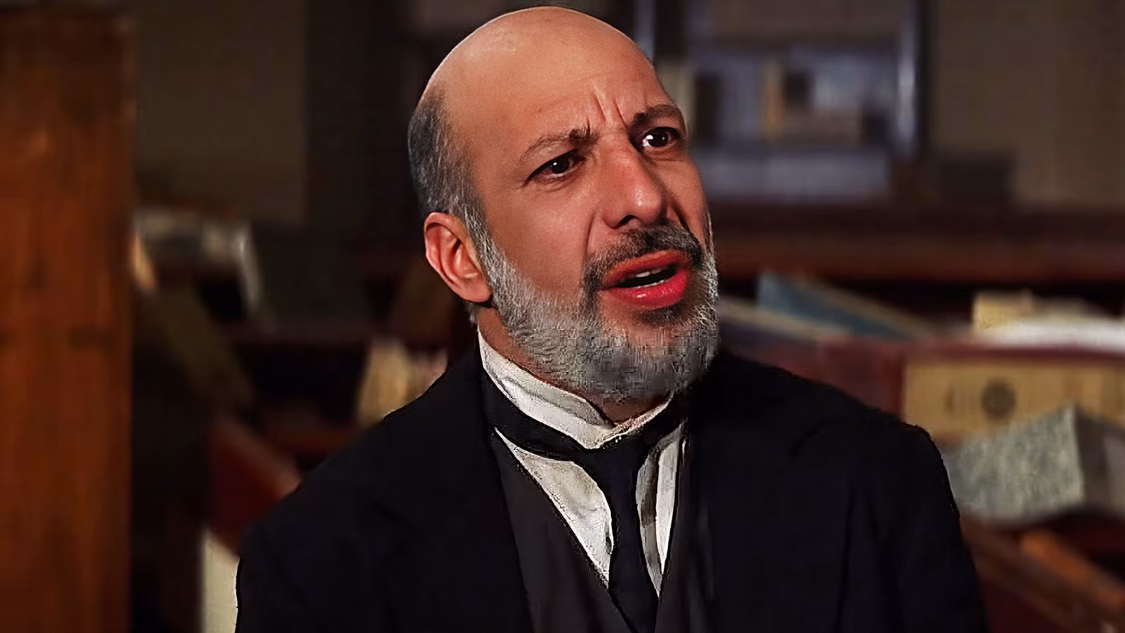 Erick Avari wears a suit and looks off camera in The Mummy