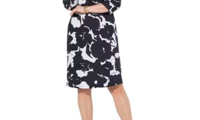 A woman wearing a plus-size black-and-white floral dress with red pumps