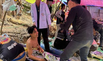 Rescuers free 4 men who had been trapped in flooded Laos cave and search for 2 still missing