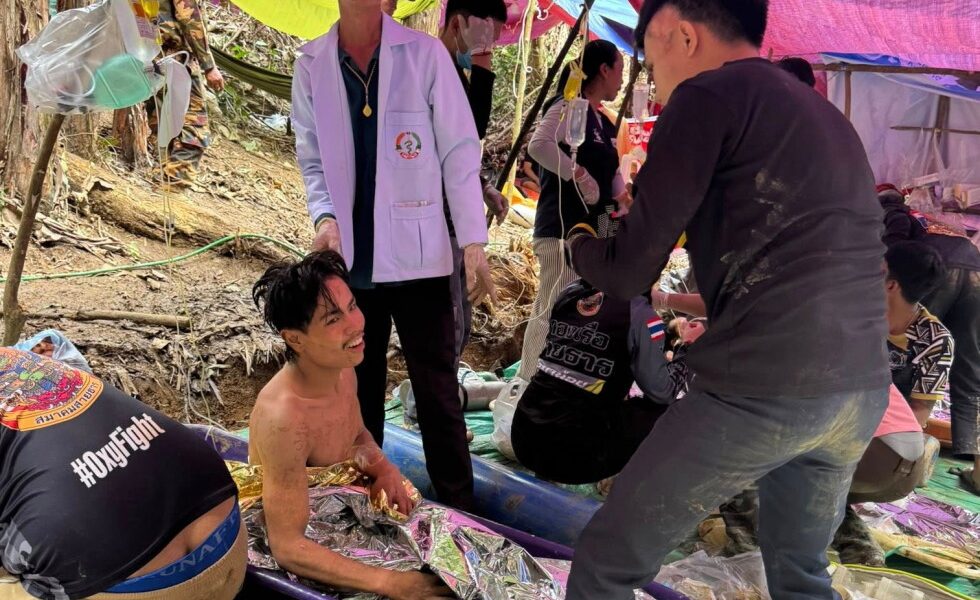 Rescuers free 4 men who had been trapped in flooded Laos cave and search for 2 still missing
