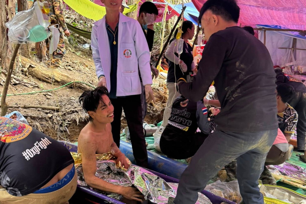 Rescuers free 4 men who had been trapped in flooded Laos cave and search for 2 still missing