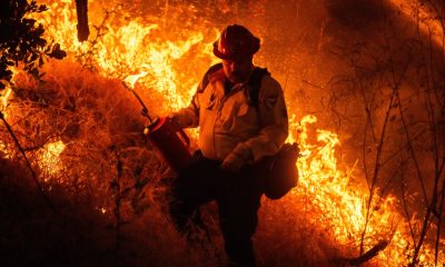 Raging wildfires churn through dry brush in Southern California