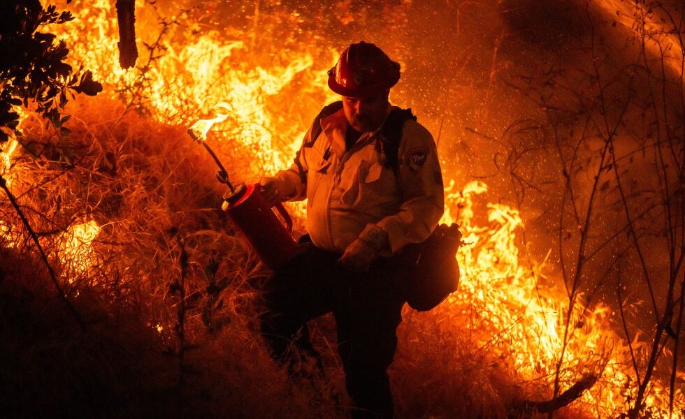 Raging wildfires churn through dry brush in Southern California