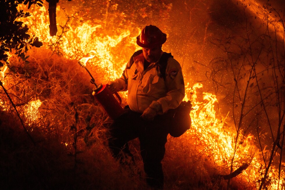 Raging wildfires churn through dry brush in Southern California
