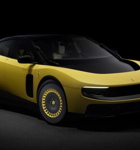A promotional image of a yellow version of the electric Ferrari Luce, photographed in a dark studio.