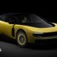 A promotional image of a yellow version of the electric Ferrari Luce, photographed in a dark studio.
