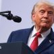 President Donald Trump speaking on stage during a press conference at the G7 Leaders' Summit