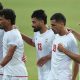 Six Iran players, wearing white Iran shirts, stand in a line