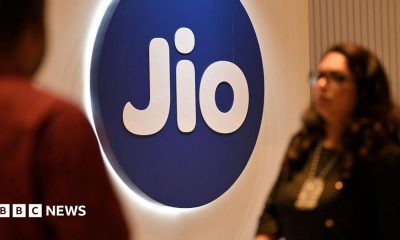People walk past a Jio signage at an event in Mumbai, India, on 3 May 2025.