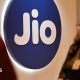 People walk past a Jio signage at an event in Mumbai, India, on 3 May 2025.