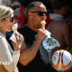 A man and a woman eating ice cream cones in the sunshine